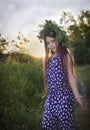 Portrait of a young teen girl in wreath of wild flowers and background of nature Royalty Free Stock Photo