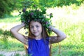 Portrait of a young teen girl in wreath of wild flowers and background of nature Royalty Free Stock Photo