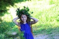 Portrait of a young teen girl in wreath of wild flowers and background of nature Royalty Free Stock Photo