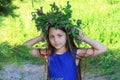 Portrait of a young teen girl in wreath of wild flowers and background of nature Royalty Free Stock Photo