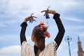 Portrait of young teenage girl in black dance dress, white shawl and pink carnations in her hair, dancing flamenco with castanets Royalty Free Stock Photo