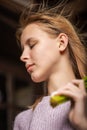 Portrait of a young teenage girl with flying hair with closed eyes on a dark background. Vertical photo Royalty Free Stock Photo