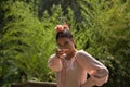 Portrait of young teenage woman in pink shirt, black skirt with flowers and pink carnations in her hair, dancing flamenco on Royalty Free Stock Photo