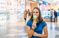 Young teenager brunette girl with long hair eating tasty cone ice cream in shopping mall Royalty Free Stock Photo