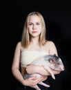 Portrait of young teenager girl with mini pig, portrait. Royalty Free Stock Photo