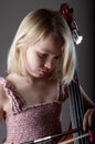 Portrait of a young teenager girl in studio with a cello Royalty Free Stock Photo