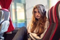 Portrait of a young teenager girl on a trip on a bus. Selective focus. Travel and tourism concept. The models wearing grey hoodie