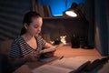 portrait of a young teenager junior school student studying at home in evening. homeschooling. distance education Royalty Free Stock Photo