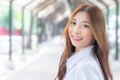 Portrait of young Thai student in university student uniform. Asian cute girl standing smiling happily where her teeth are wearing Royalty Free Stock Photo