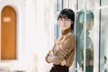 Portrait young thin glasses smiling woman looking camera crossed arms. Happy girl standing in office background. Successful Asian Royalty Free Stock Photo