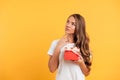 Portrait of a young thoughtful girl holding gift box Royalty Free Stock Photo