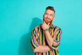 Portrait of young thoughtful red haired successful business man touch chin his long beard look novelty isolated on blue Royalty Free Stock Photo