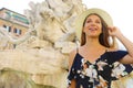 Portrait of young tourist woman visiting Piazza Navona square landmark in Rome. Summer holidays in Italy