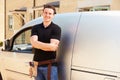 Portrait of a young tradesman by his van Royalty Free Stock Photo