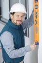 portrait young tradesman using spirit level Royalty Free Stock Photo