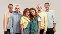 Portrait of young twin brothers and sisters smiling at camera, posing together, standing isolated over light background Royalty Free Stock Photo