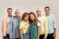 Portrait of young twin brothers and sisters smiling at camera, posing together, standing isolated over light background Royalty Free Stock Photo