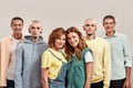 Portrait of young twin brothers and sisters smiling at camera, posing together, standing isolated over light background Royalty Free Stock Photo