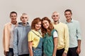 Portrait of young twin brothers and sisters smiling at camera, posing together, standing isolated over light background Royalty Free Stock Photo