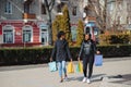 Portrait of young two african ladies friends standing over red wall and posing with shopping bags Royalty Free Stock Photo