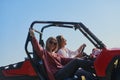 girls enjoying a beautiful sunny day while driving an off-road car Royalty Free Stock Photo