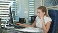 Portrait of young unhappy business woman at desk in office