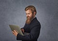 Portrait young unhappy shocked man with laptop computer isolated grey background Royalty Free Stock Photo