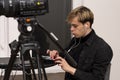 Portrait of a young video engineer 20-25 years old, conducts an online broadcast on the Internet.