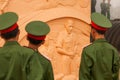 Portrait of young vietnamese soldier in green uniform looking at statue of the French General De Castries at the bunker. Dien Bien