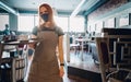 Young waitress standing in cafe. girl the waiter holds in bunches a tray with utensils. Restaurant service Royalty Free Stock Photo