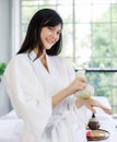 Portrait young and well healthy Asian woman a long black hair wears a white robe and relaxed after a massage spa. Look smiling and Royalty Free Stock Photo