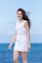 Girl in short white sleeveless dress looking at camera laughing Royalty Free Stock Photo