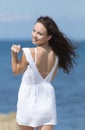 Girl in short white sleeveless dress takes off it Royalty Free Stock Photo