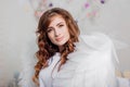 Portrait of a young woman, an angel in a white dress stands wrapped in wings Royalty Free Stock Photo