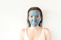 Portrait of young woman applying face clay mask. Royalty Free Stock Photo