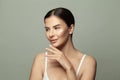 Portrait of young woman applying moisturizer cream on her pretty face. Spa, beauty and skin care concept Royalty Free Stock Photo