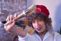 Portrait of young woman, artist, designer and painter with a red beret, with brushes and paintbrushes in hand and looking through Royalty Free Stock Photo