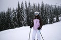 Young woman athlete posing on skis on a mountain slope. professional sportsman is skiing. winter sport Royalty Free Stock Photo