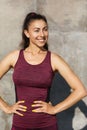 Portrait of a young woman athlete in a warm summer sunny morning near a wall on the street