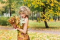 Portrait of young woman. Autumn, dress with leafs. Park Royalty Free Stock Photo