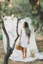 Portrait of young woman on background of white hanging textile cloth in garden Royalty Free Stock Photo