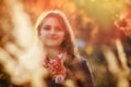 Portrait of a young woman on a background of yellow foliage. The girl looks at the camera, autumn landscape Royalty Free Stock Photo