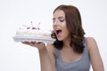 Portrait of a young woman bitting cake