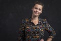 Portrait of a young woman on a black background. Attractive natural girl in a black shirt. Studio shot girl looking at the camera. Royalty Free Stock Photo