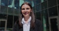 Portrait of a young woman in a black suit looking to camera outside on street. Businesswoman portrait near office Royalty Free Stock Photo