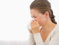 Portrait of young woman blowing nose Royalty Free Stock Photo