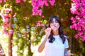 Happy beautiful young woman blowing soap bubbles outdoor. Royalty Free Stock Photo