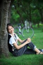 Portrait of young woman with blur biclycle background relaxing i Royalty Free Stock Photo