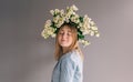 Portrait of a young woman with a bouquet of roses on a gray background. Royalty Free Stock Photo