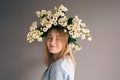 Portrait of a young woman with a bouquet of roses on a gray background. Royalty Free Stock Photo